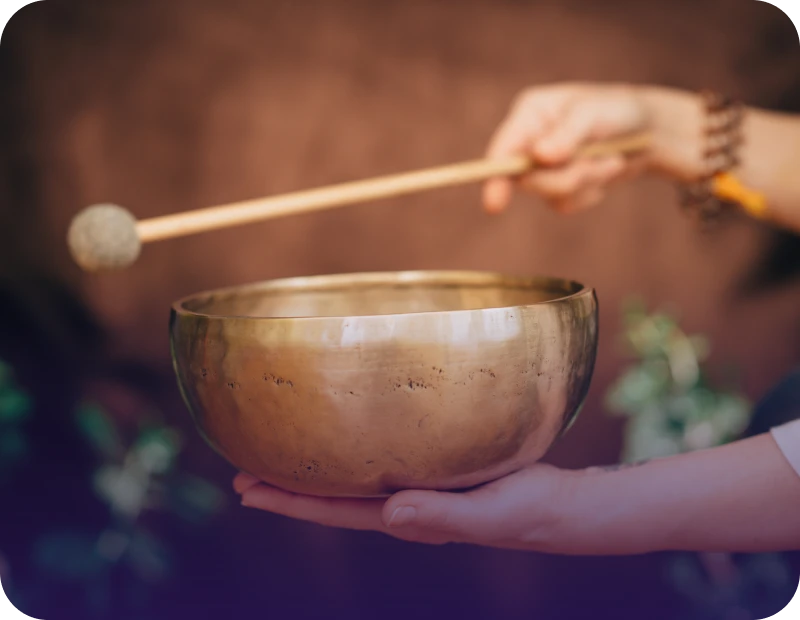 Hand holding a singing bowl